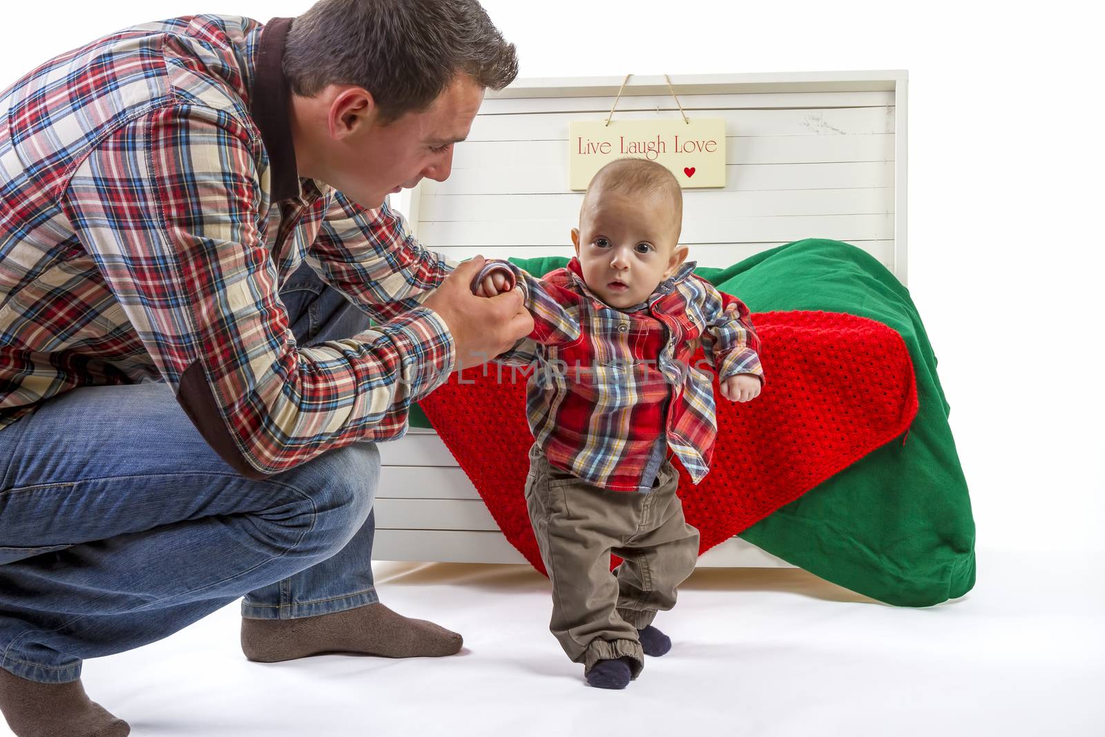 Baby boy with his father on white background