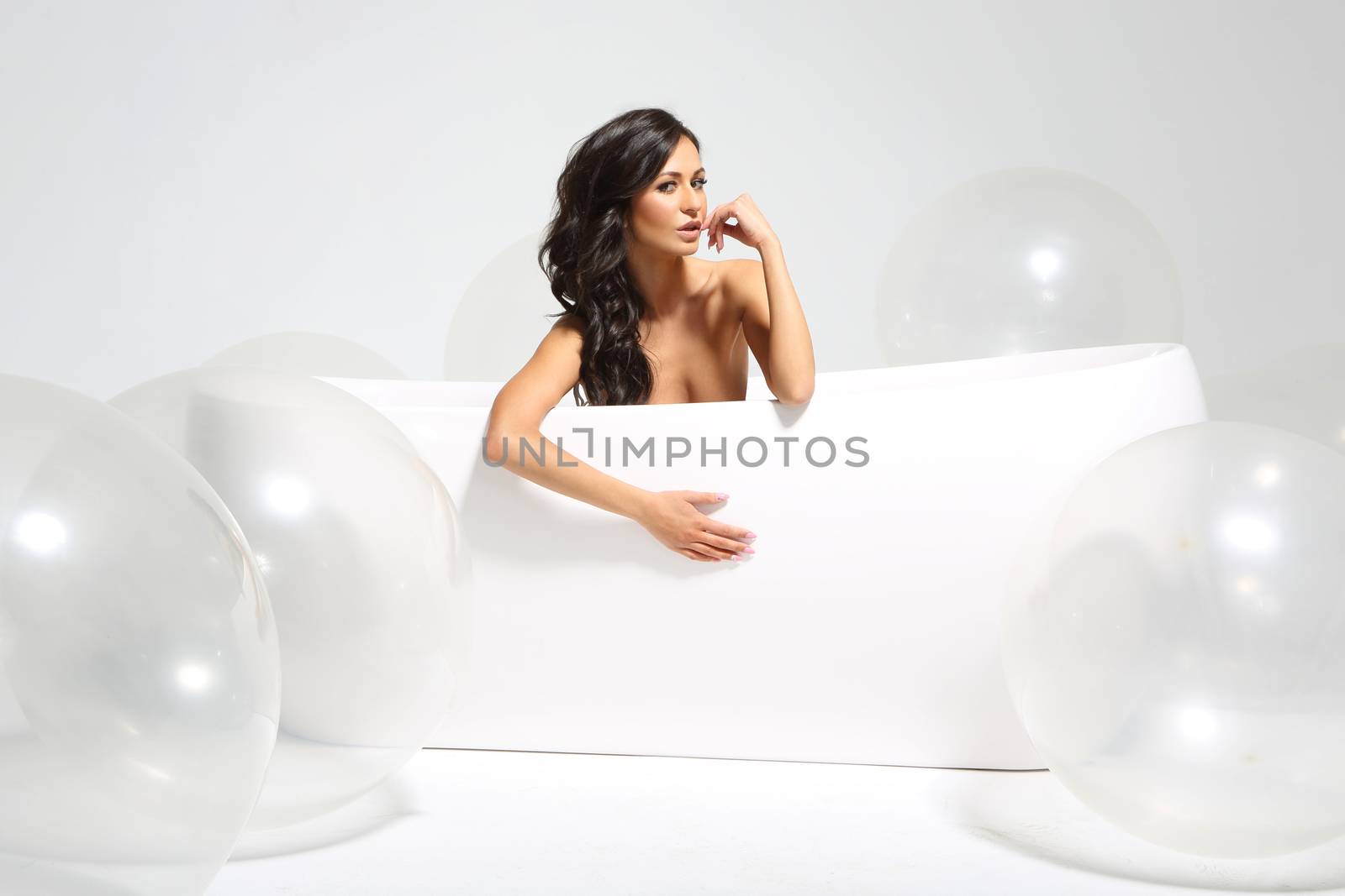 Beautiful hispanic, latino  in a bathtub full of large bubbles