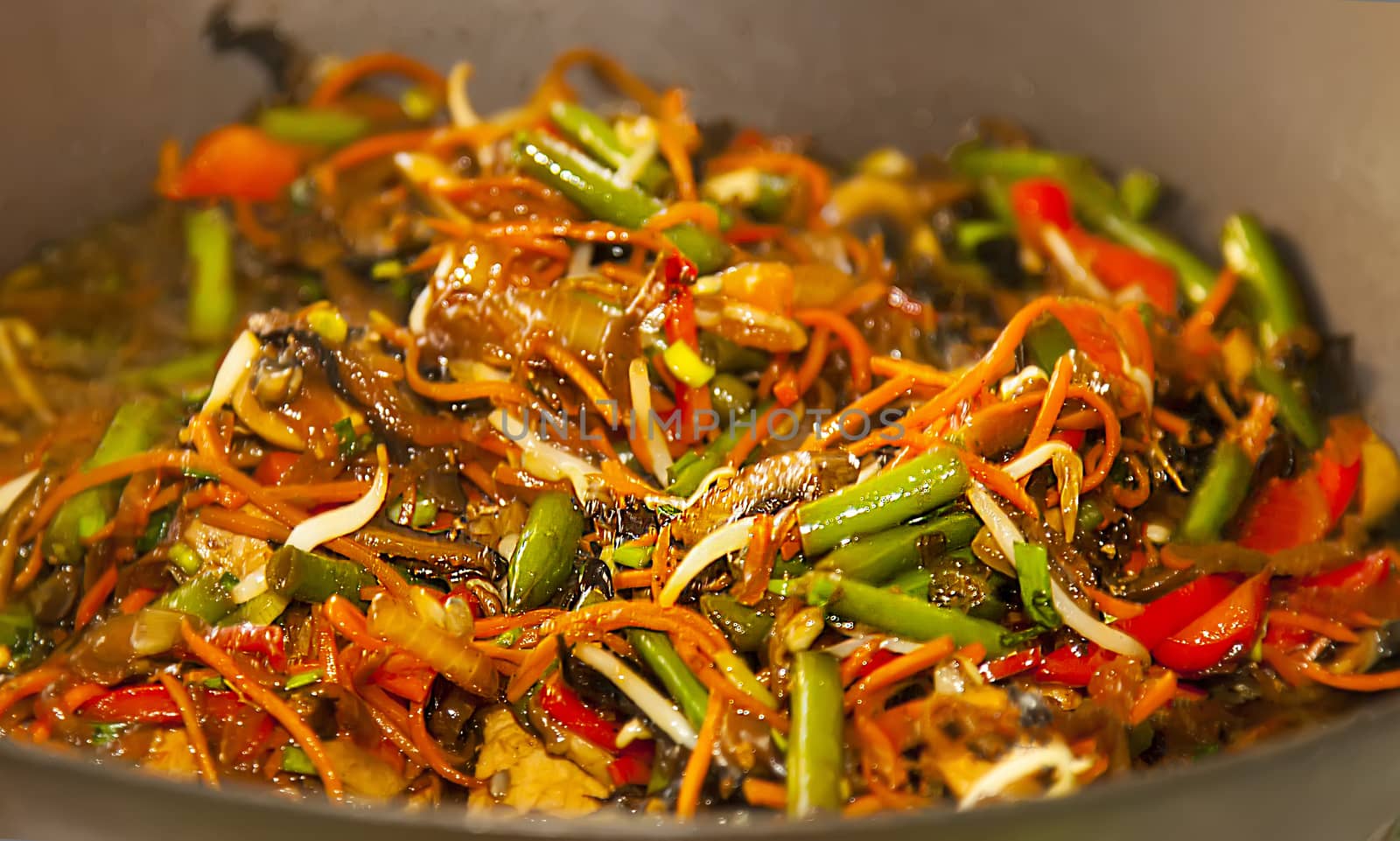 Asian noodles with vegetables on wok