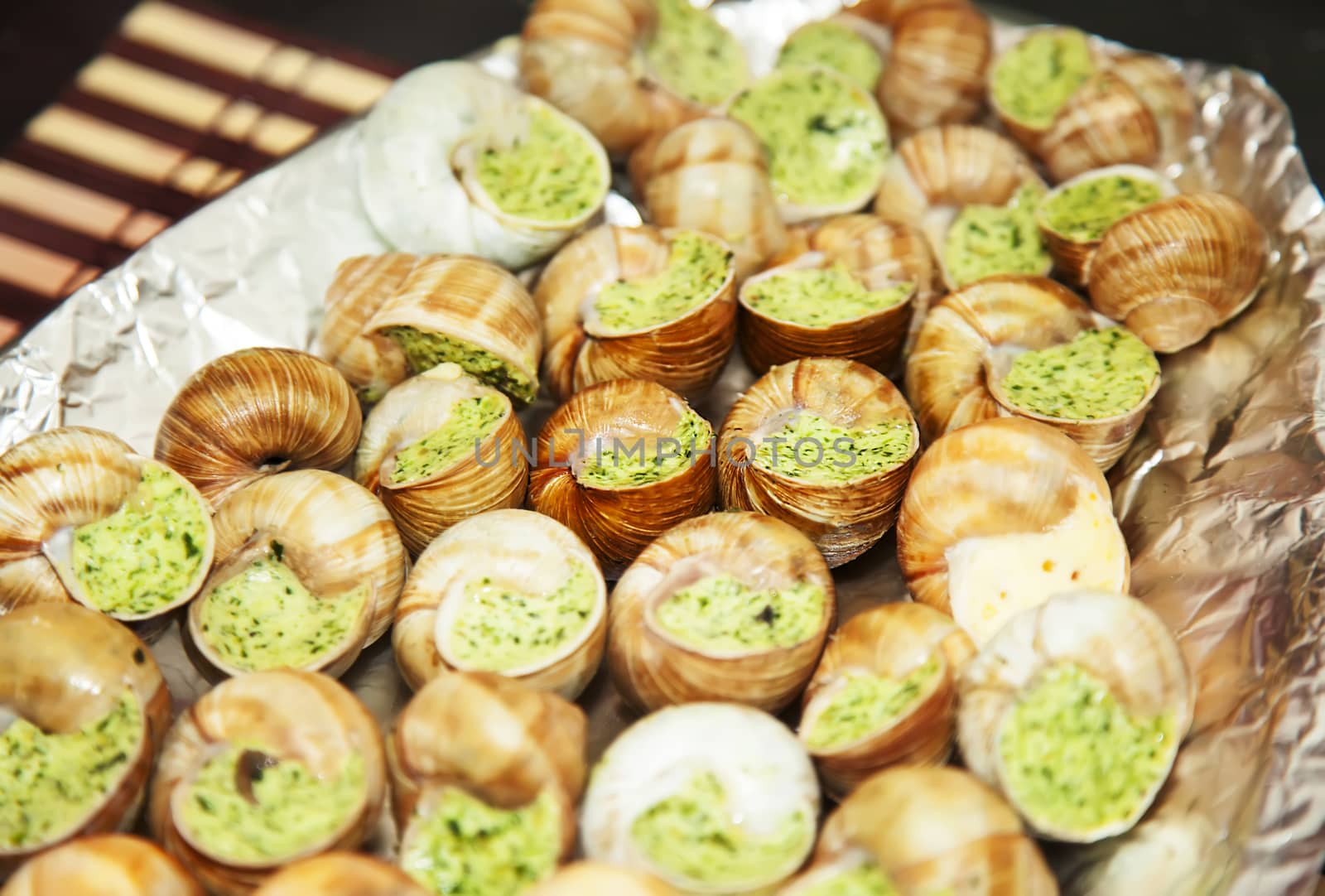 Escargots with garlic butter on plate