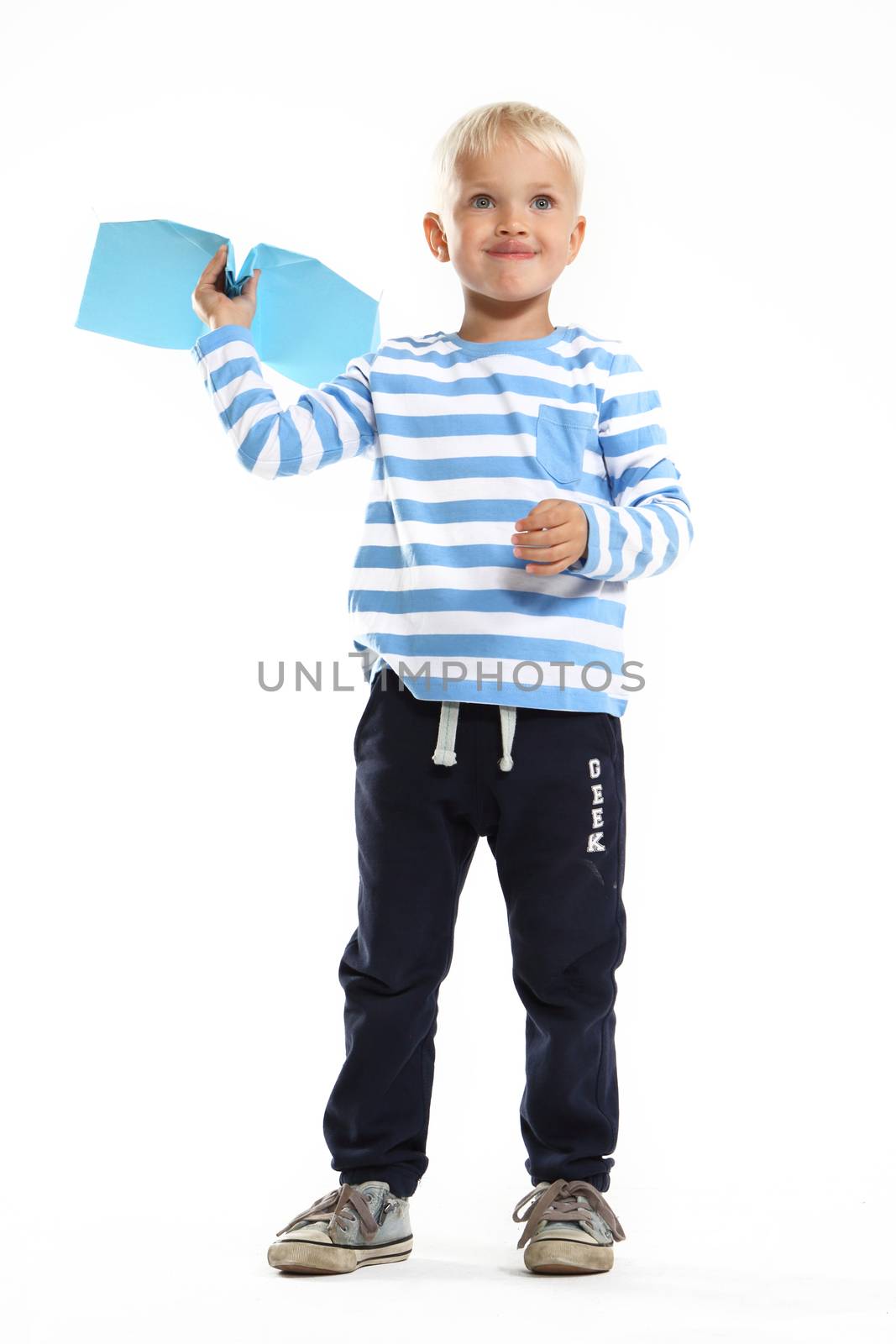 A little boy holds in his hand a paper airplane by robert_przybysz