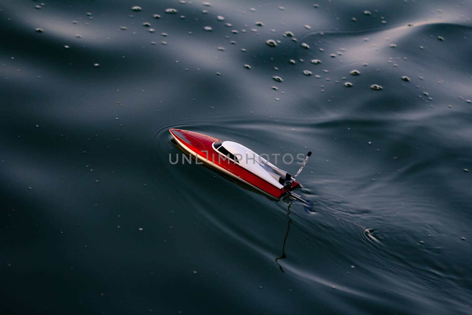 Remote control boat in the blue lake