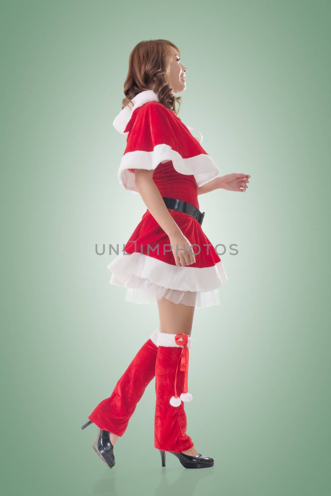 Asian Christmas girl walk, full length portrait. Side view.