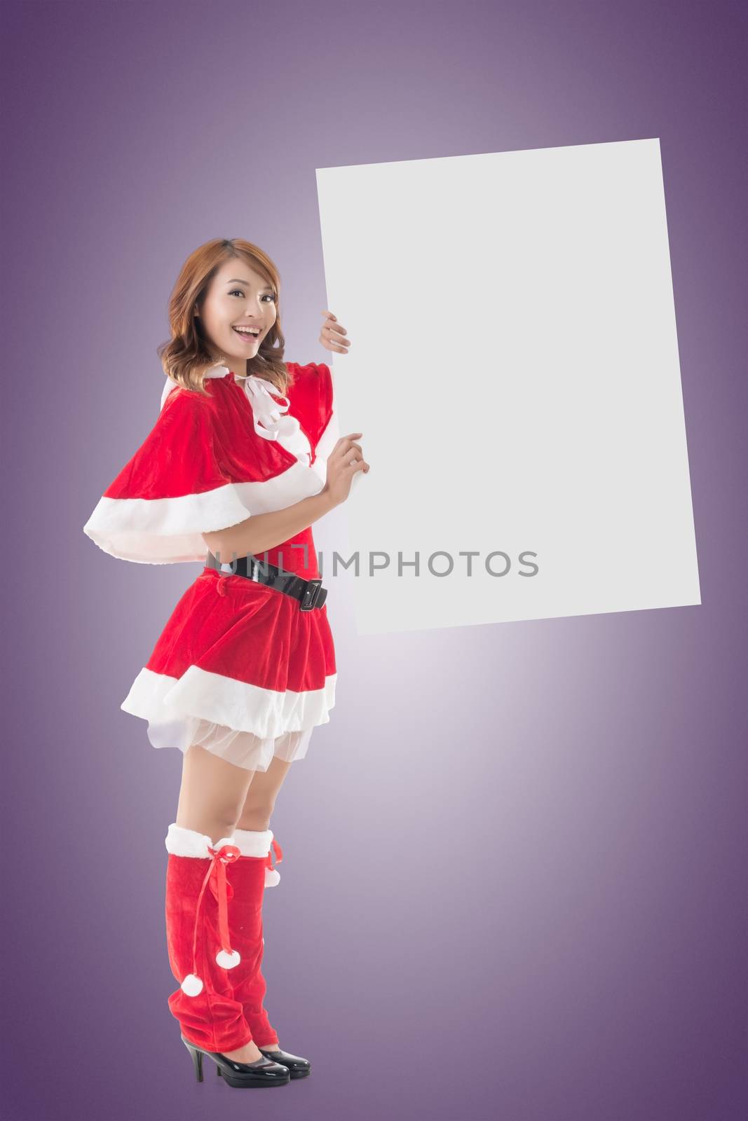 Asian Christmas girl holding a blank board, full length portrait.