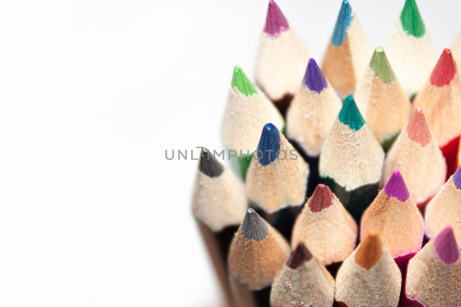 Wooden pencils in a pile on the white background.