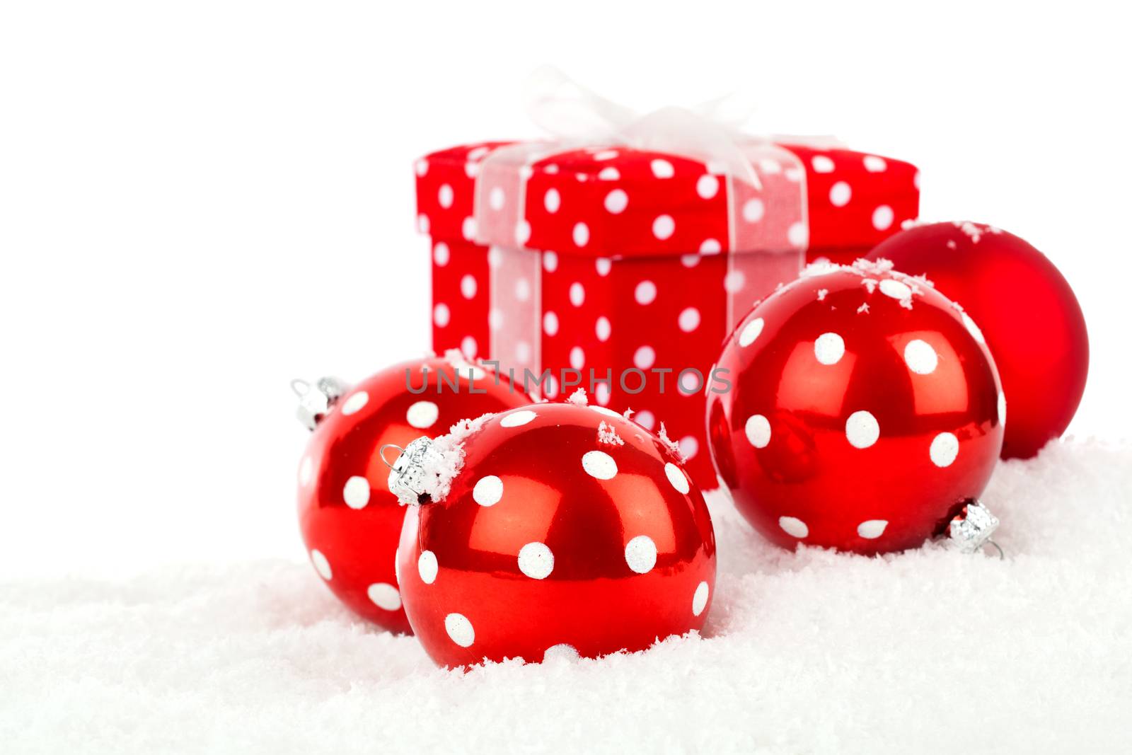 red polka dot Christmas bauble, isolated over white