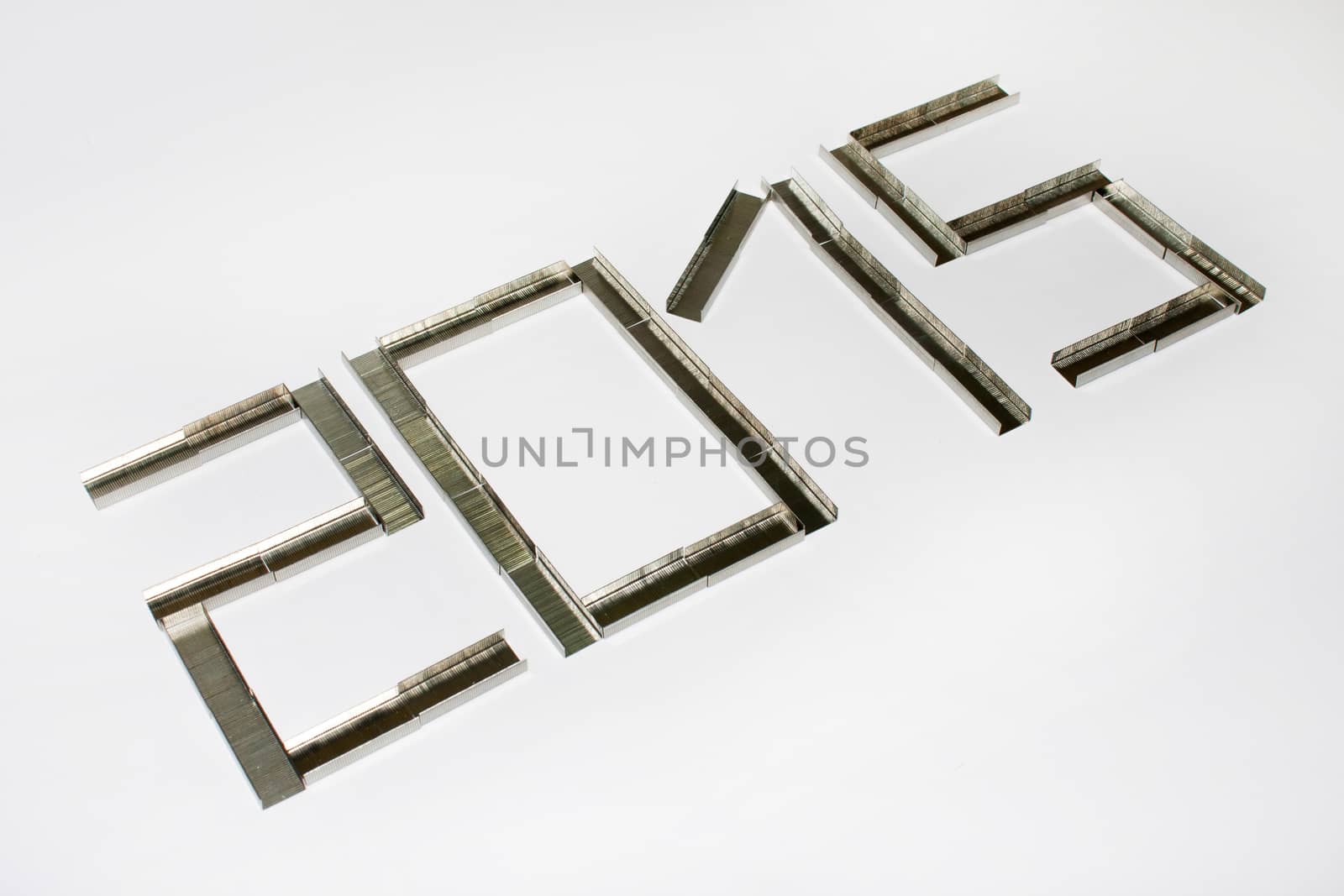 Happy new 2015 year with staples on the white background.