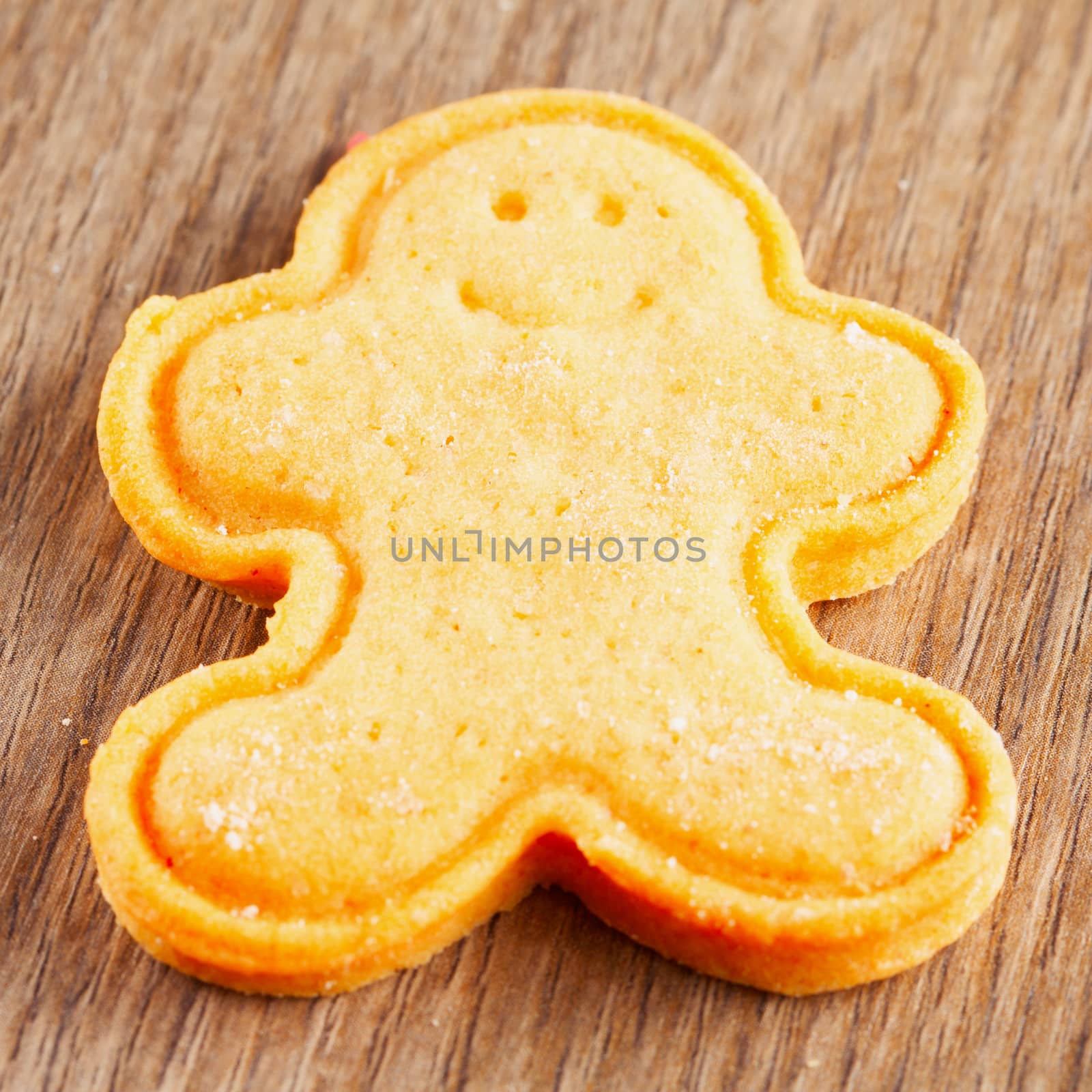 Biscuit in shape of puppet over wooden background