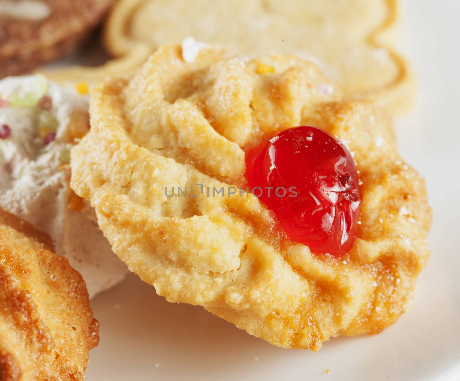 Biscuit with cherry over a white plate