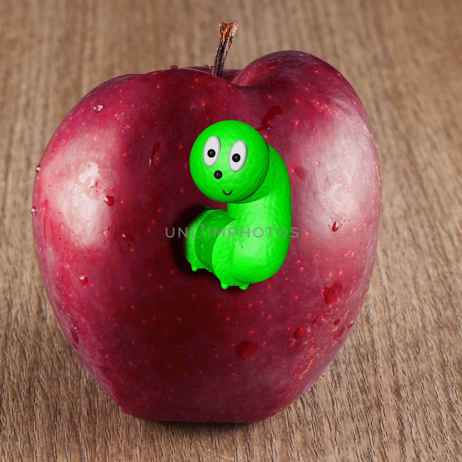 Toony worm coming out of a red apple over a wooden background