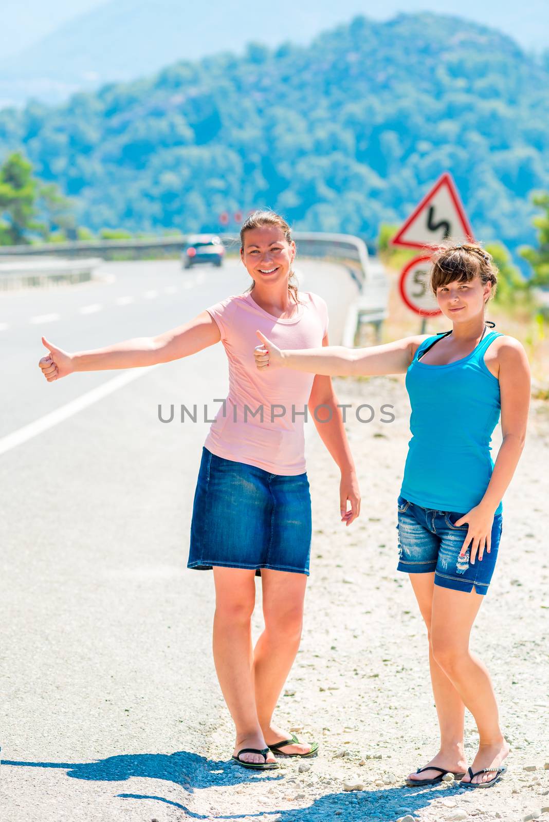 beautiful girls on the road hitchhiking