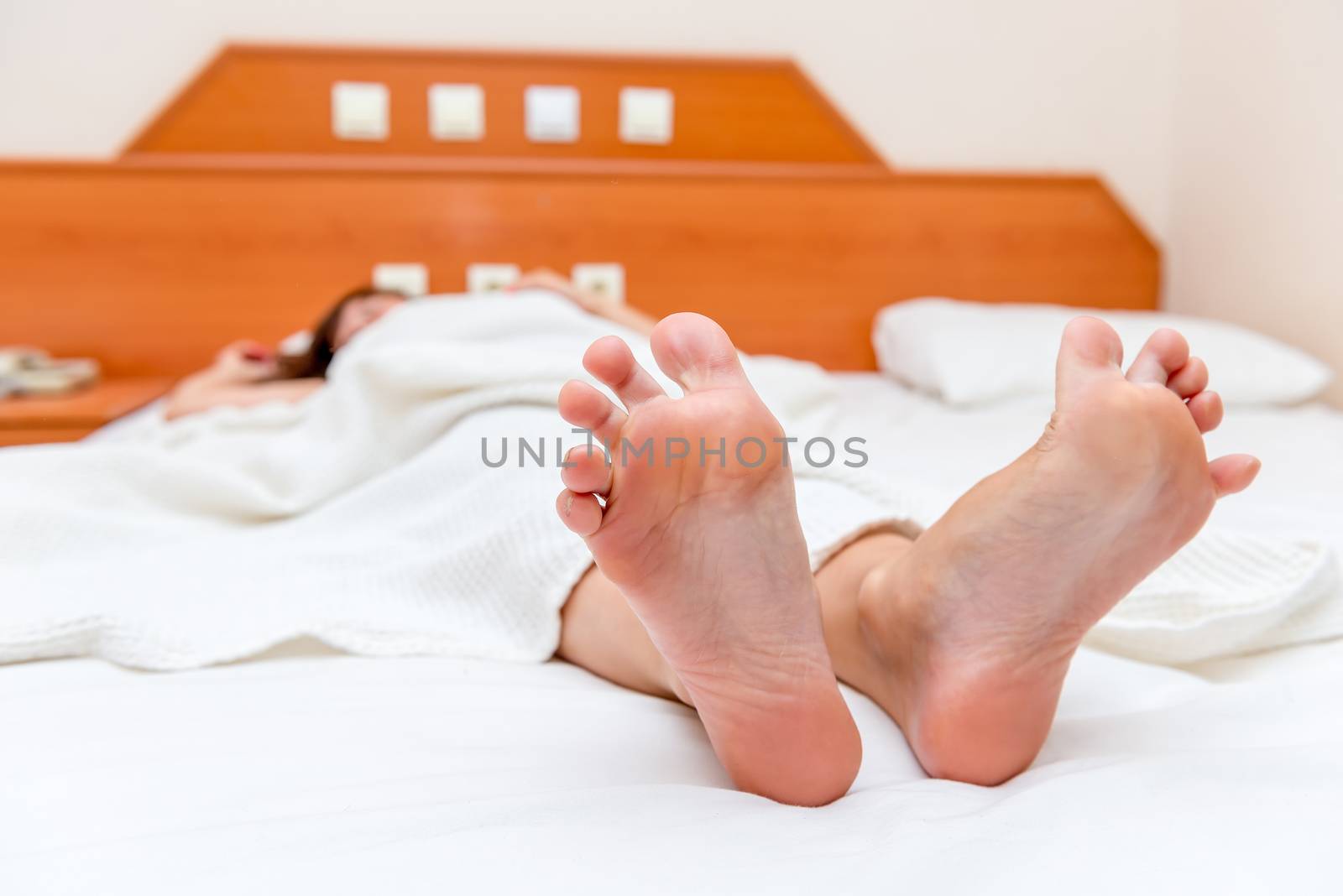 female feet close up stretch themselves upon waking