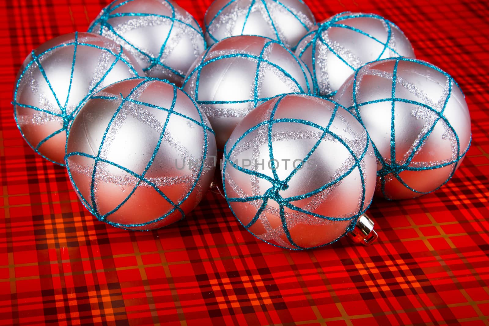 Silver Christmas balls on a red background