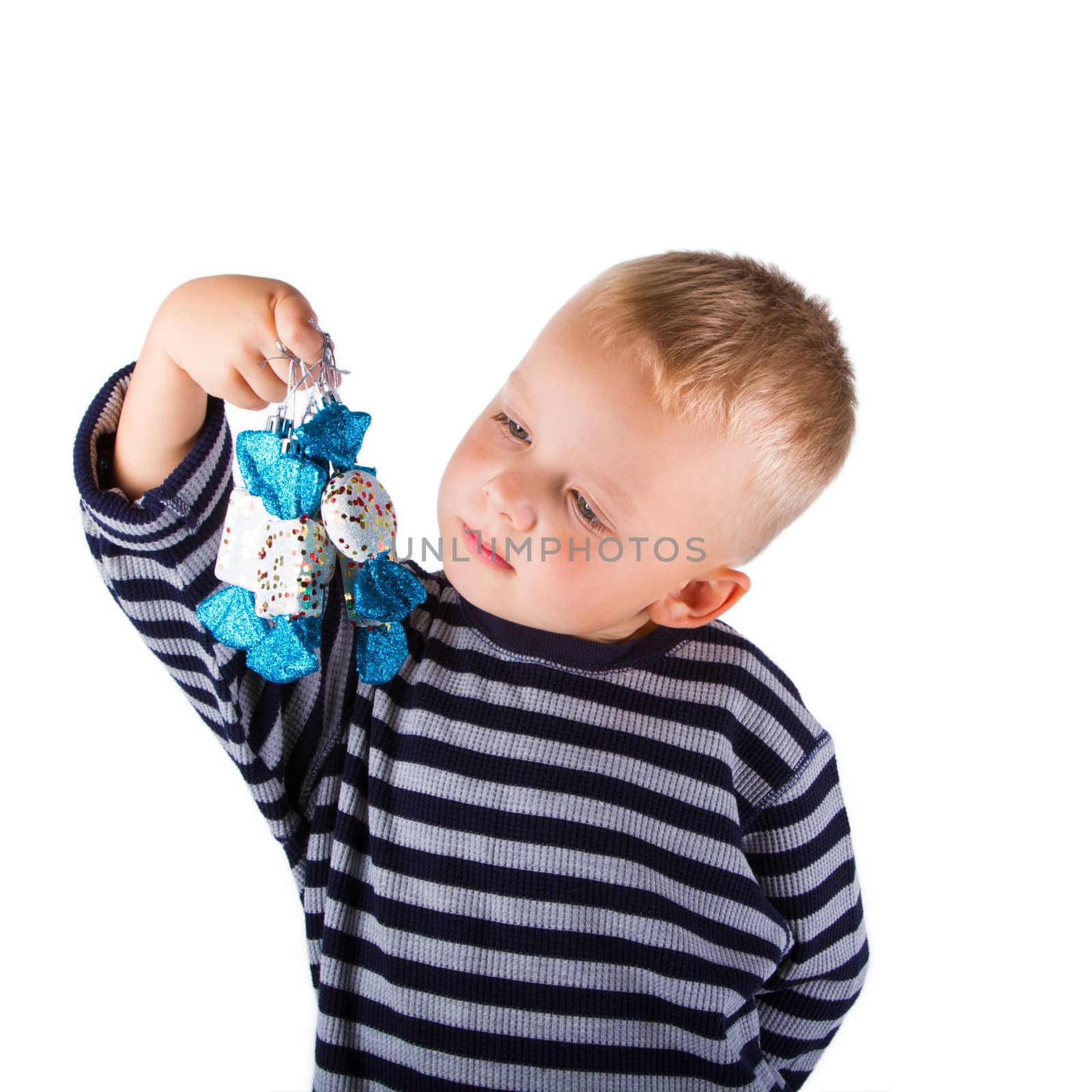 Smiling child with christmas decorations in hand. Isolated on white background