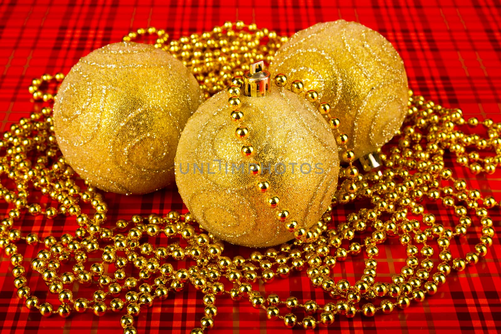 Gold Christmas balls on a red background