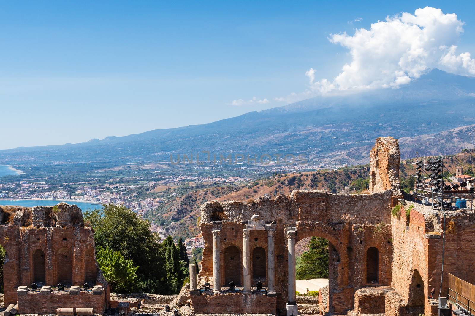 Greek theater in Taormina and Etna Mont view of volcano Etna in the background.