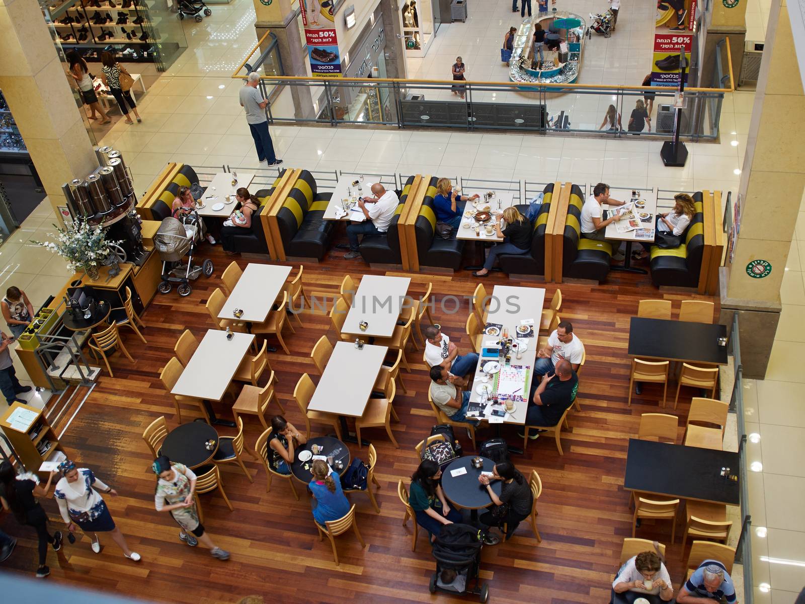 Busy popular coffee shop in a shopping center mall full of customers Israel   