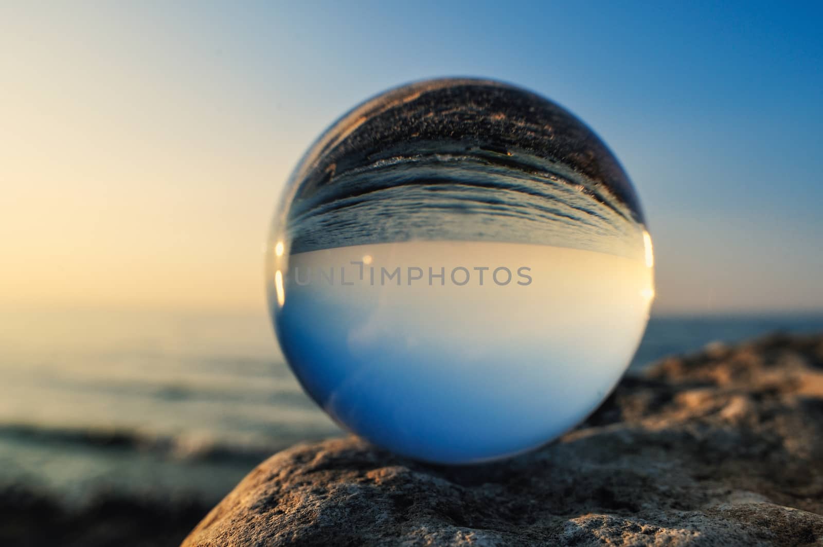 Crystal ball on the boulder at the sea