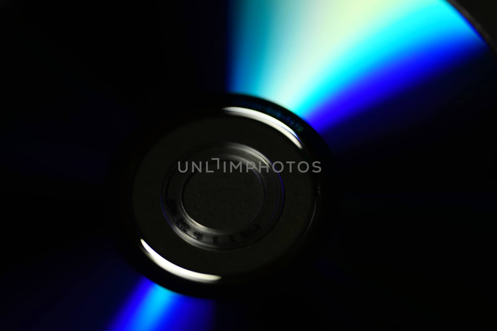 Photo of a compact disc isolated on black background. Objects photography.