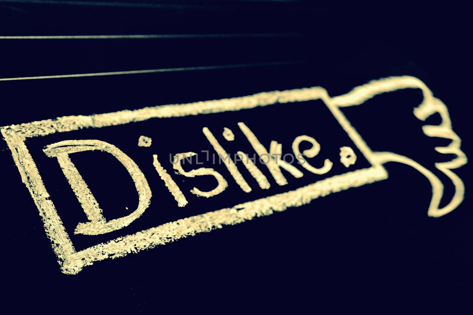 Dislike word handwritten on black chalkboard