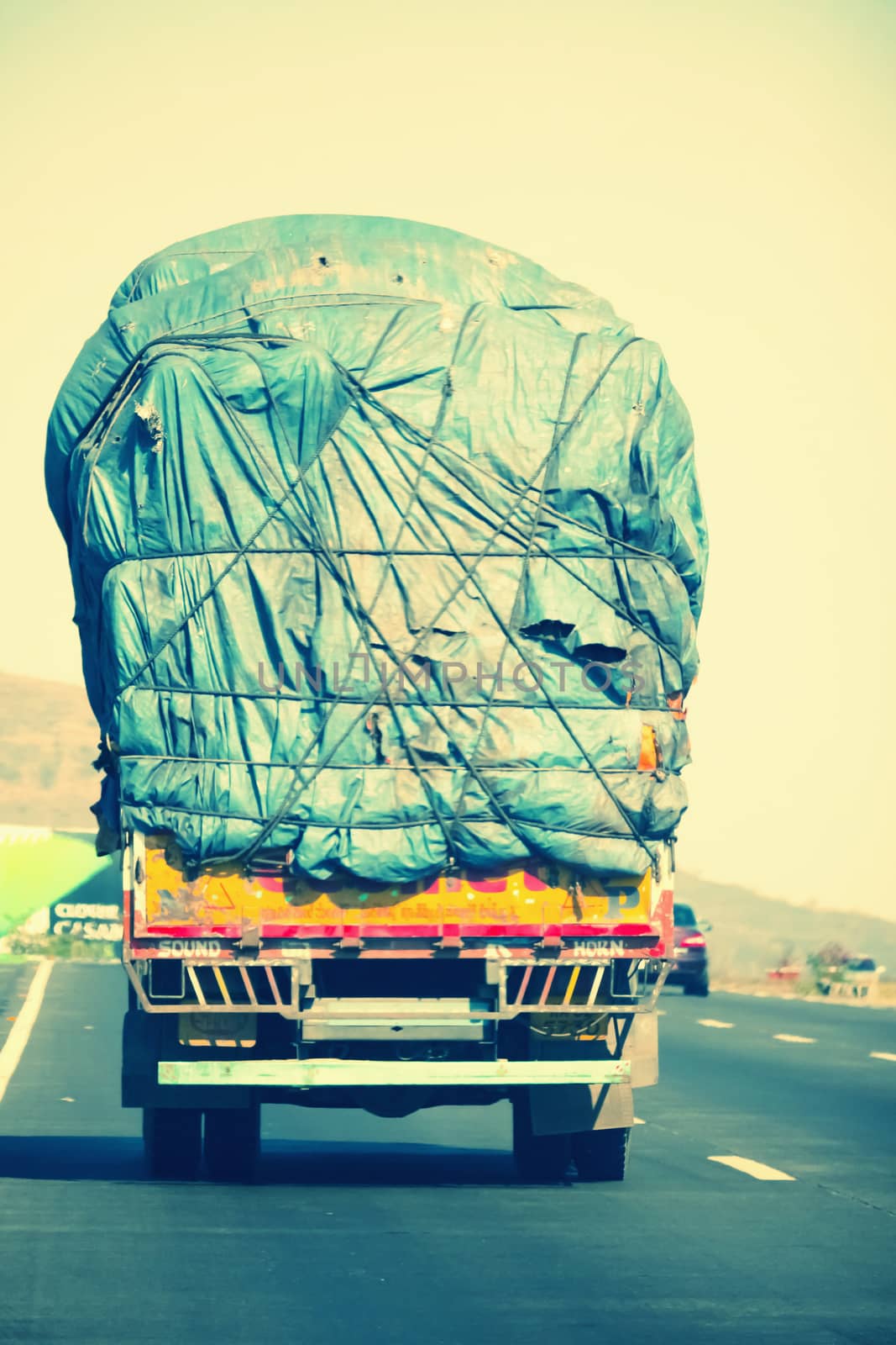 Overloaded indian lorry driving on the national highway 4