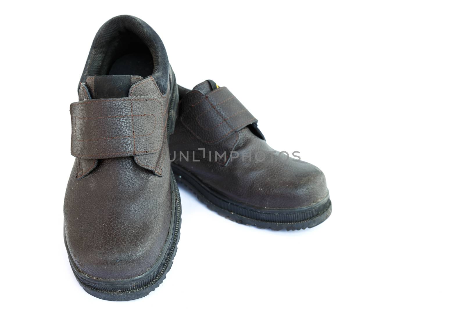 Old safety shoes isolated on white background