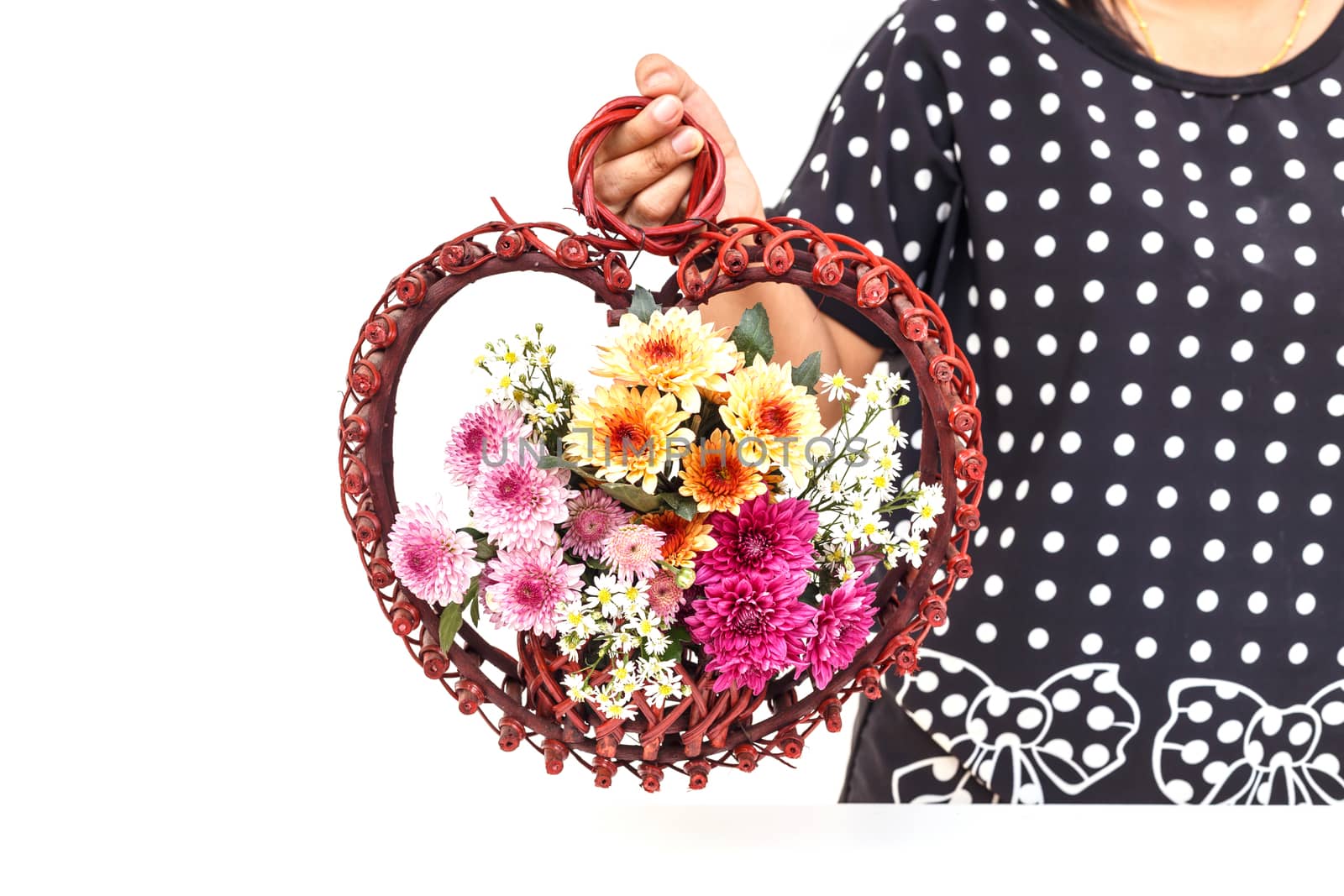 Hand holding Flower in wooden handmade basket isolated on white background
