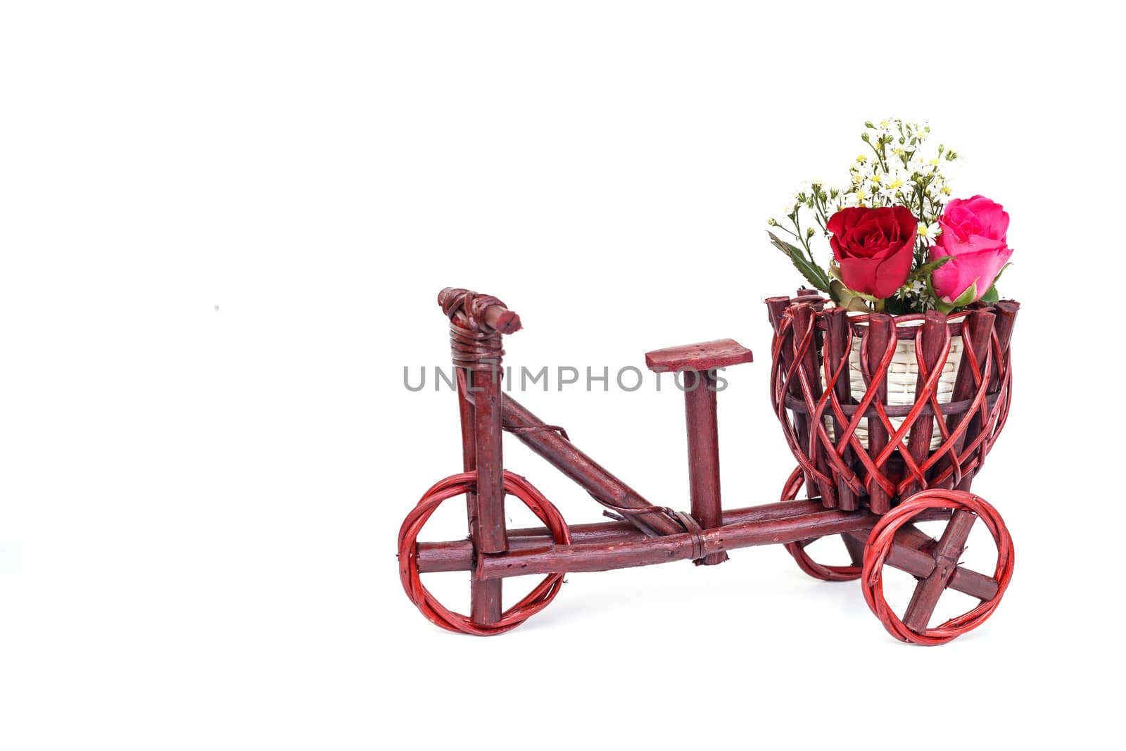 Rose flower in wooden handmade basket isolated on white background