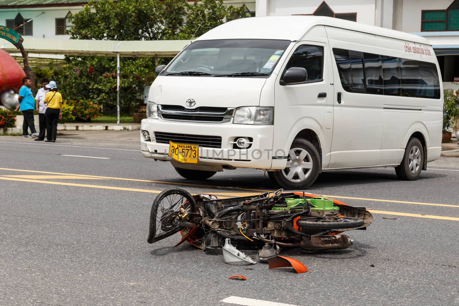 PHUKET, THAILAND - NOVEMBER 3 : Van accident on the road and crashed with motorcycle which causing the rider serious injury. November 3, 2014 in Phuket Thailand.