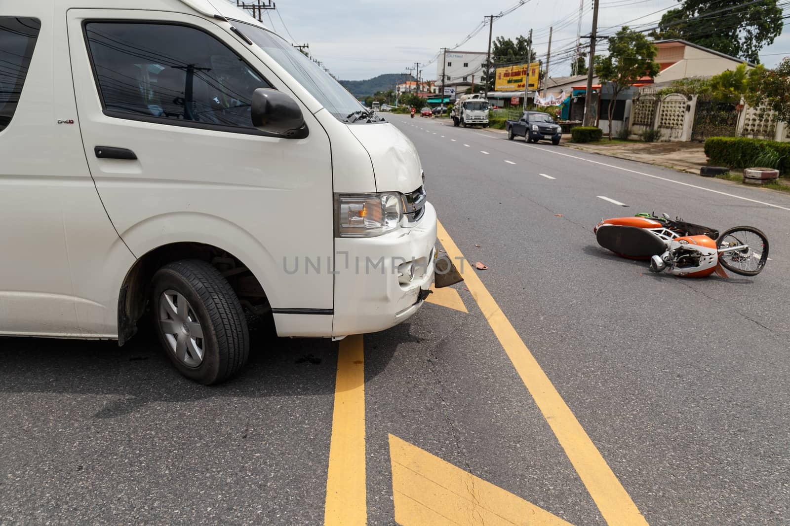 PHUKET, THAILAND - NOVEMBER 3 : Van accident on the road and crashed with motorcycle which causing the rider serious injury. November 3, 2014 in Phuket Thailand.