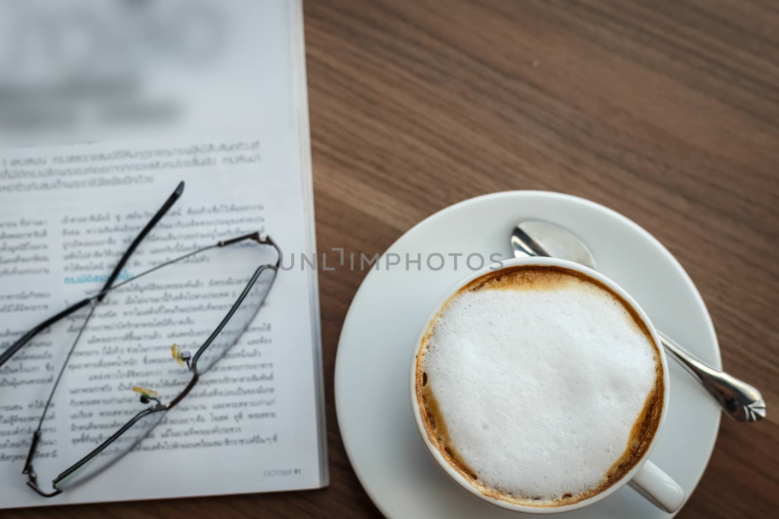 Coffee cup and book on the table