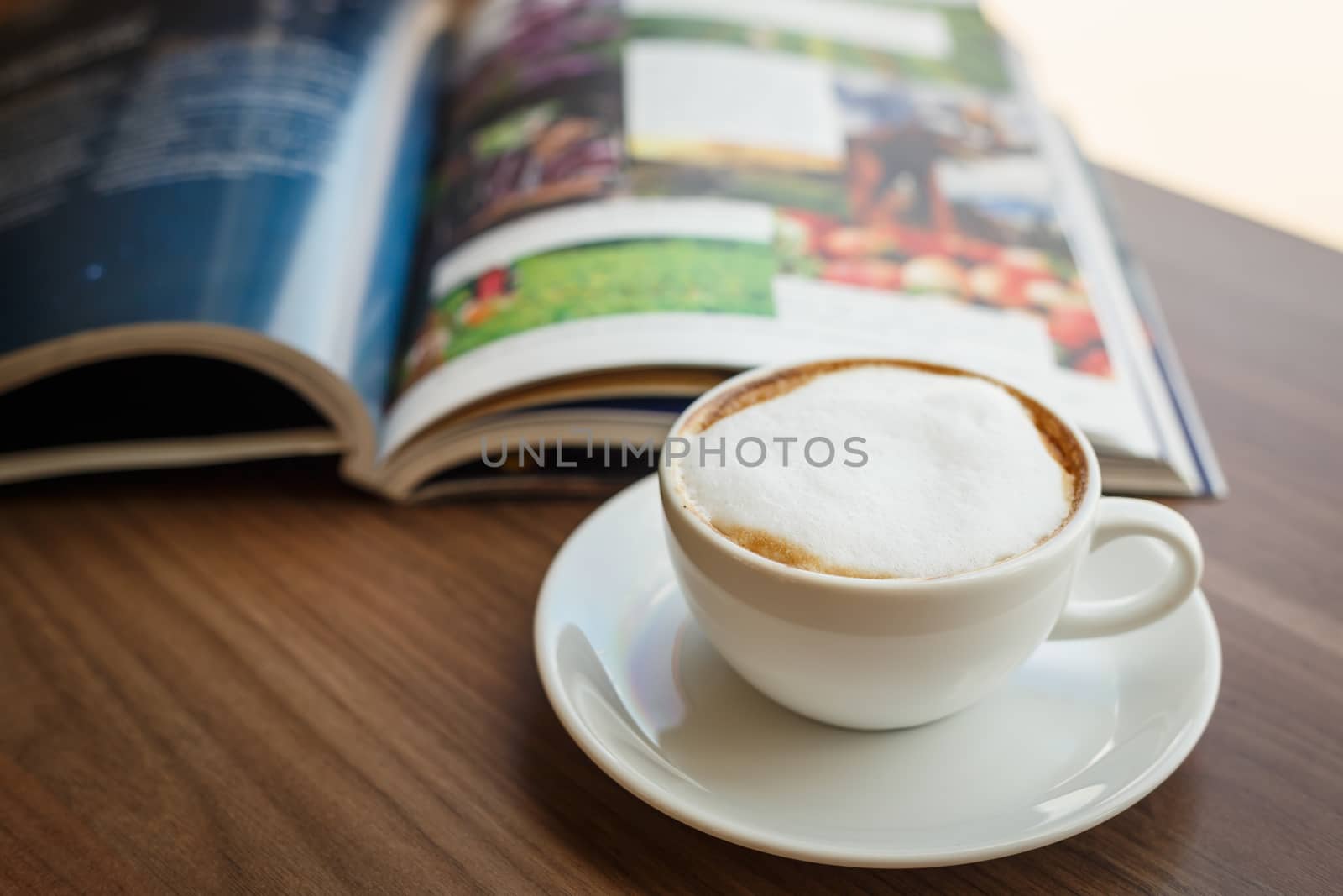 Coffee cup and book on the table