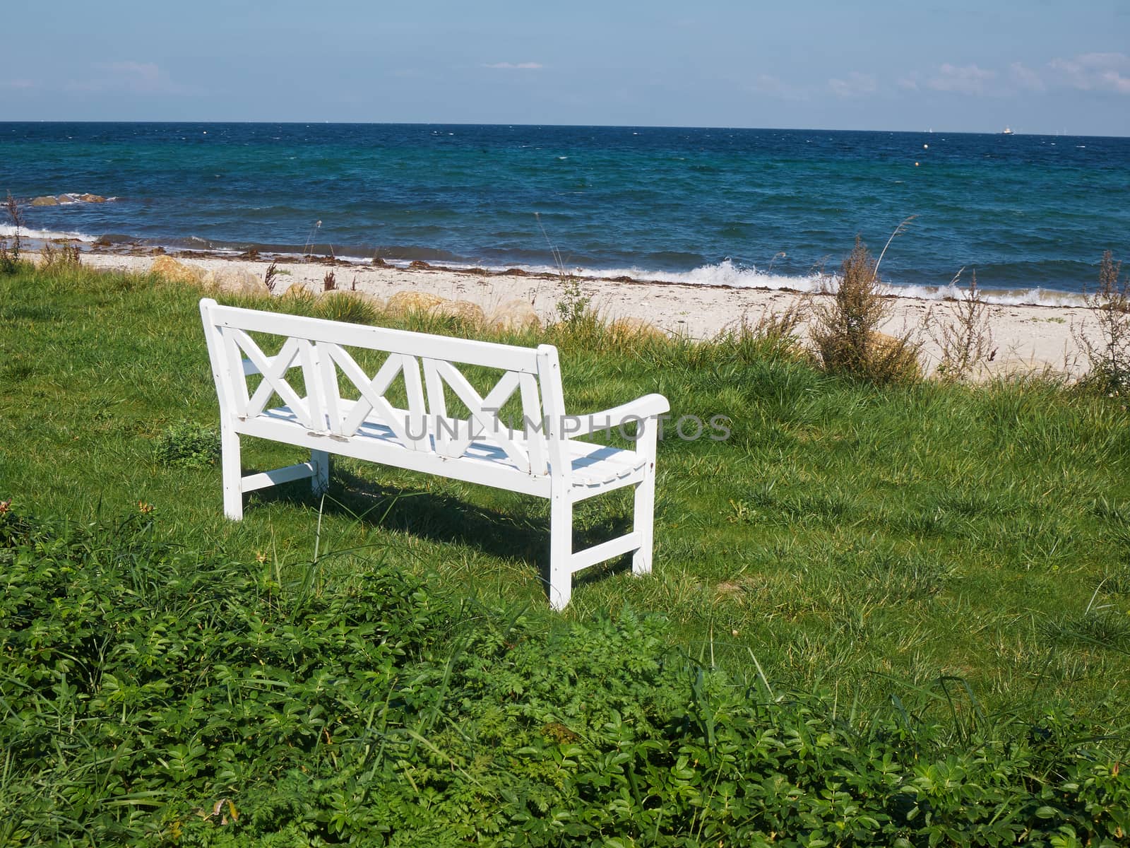 Classical vintage wooden bench seating corner on a beautiful beach     