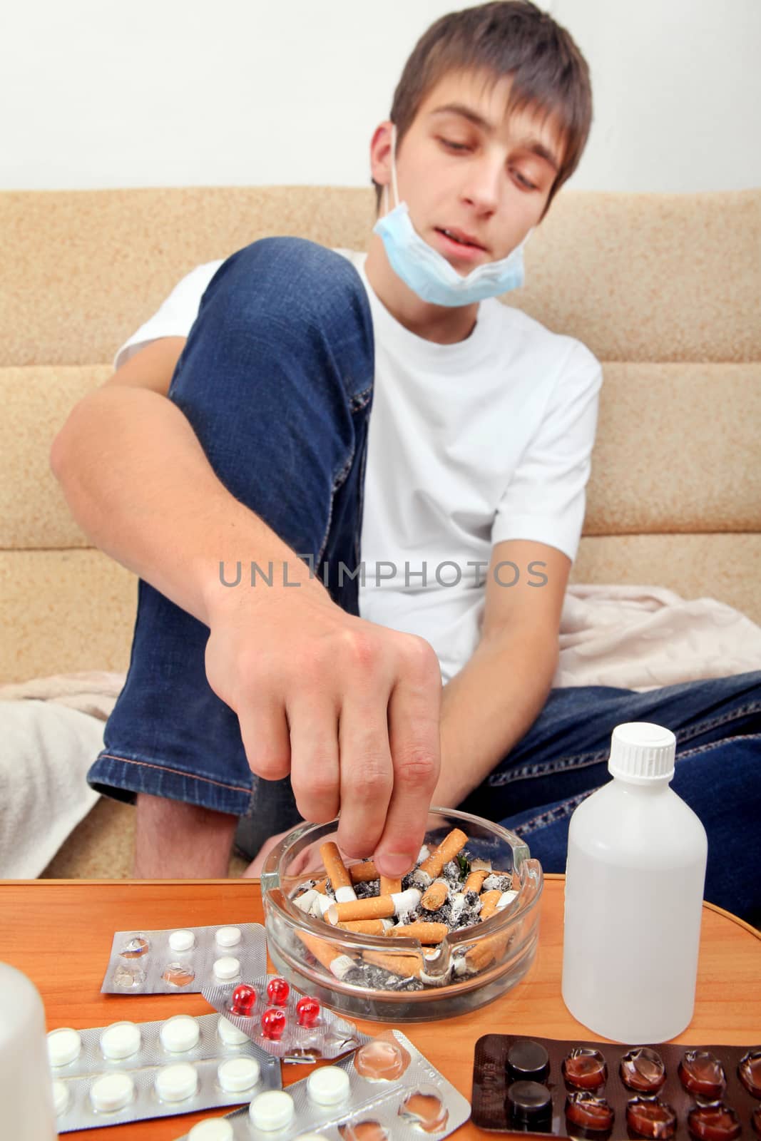 Sick Teenager smoking Cigarette Focus on ashtray