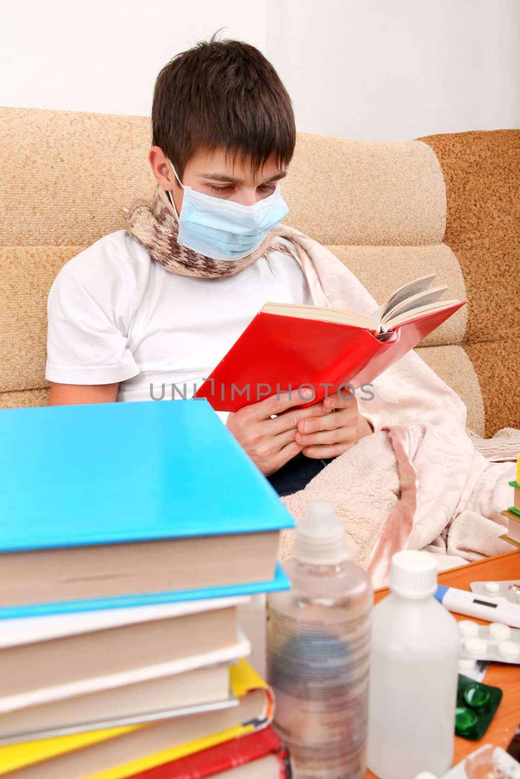 Sick Teenager in Flu Mask with the Books on the Sofa