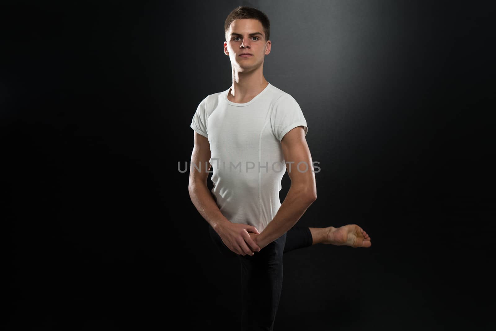 Handsome Male Ballet Dancer On A Black Background