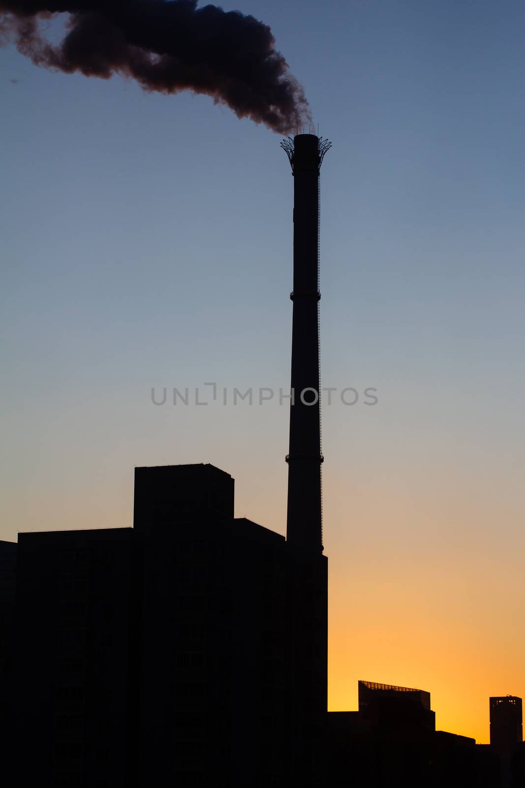 Chimney is smoking, under the twilight