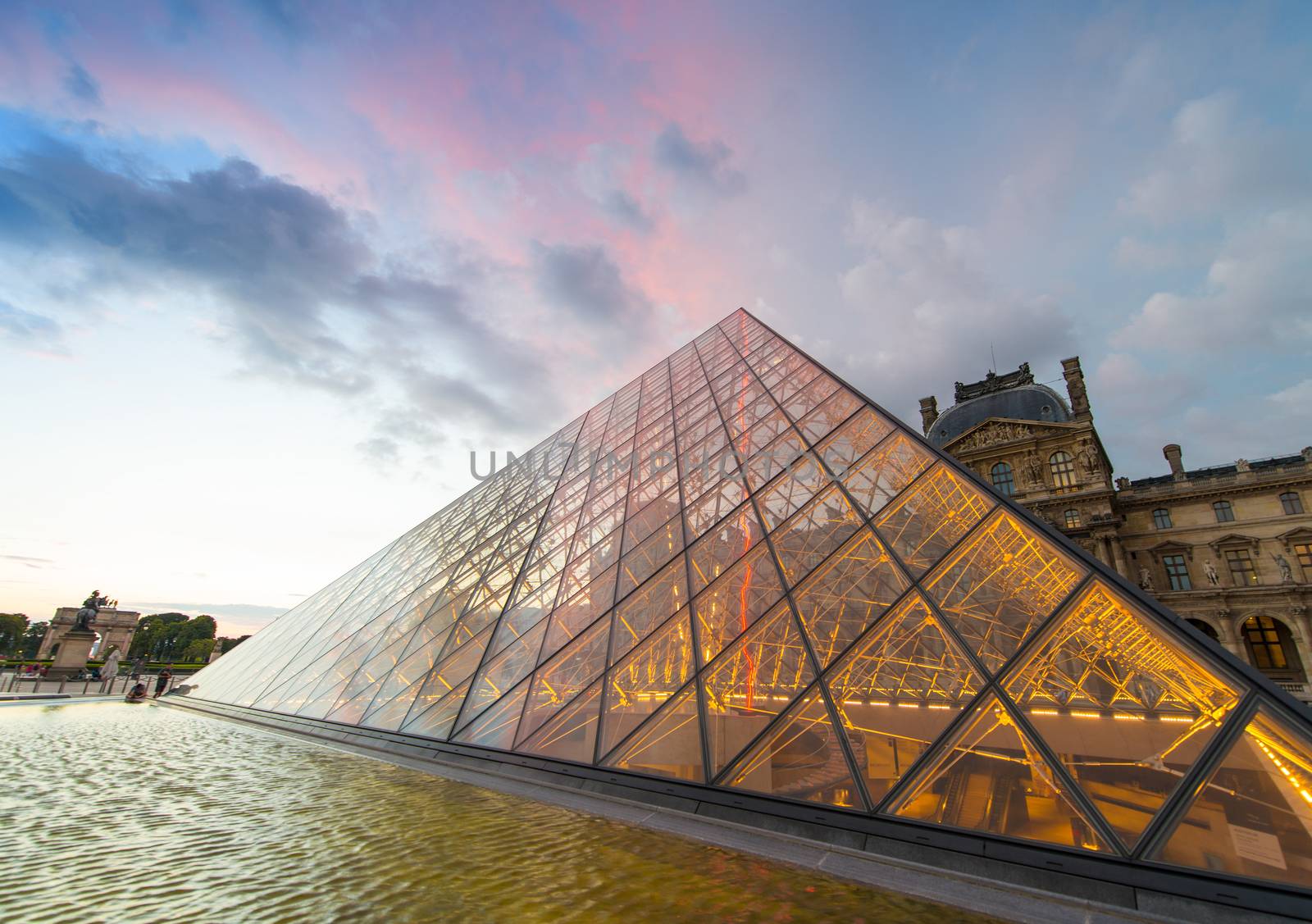 PARIS - JUNE 15 : Louvre museum at twilight in summer on June 15, 2014. Louvre museum is one of the world's largest museums with more than 8 million visitors each year