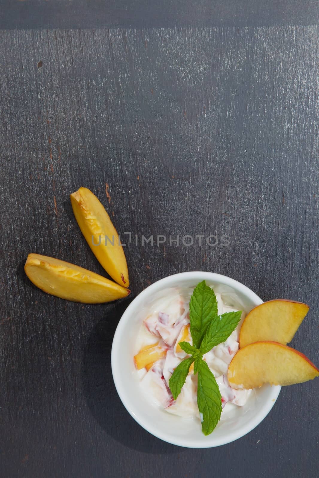 Homemade yogurt with fresh pieces of peach  by tolikoff_photography