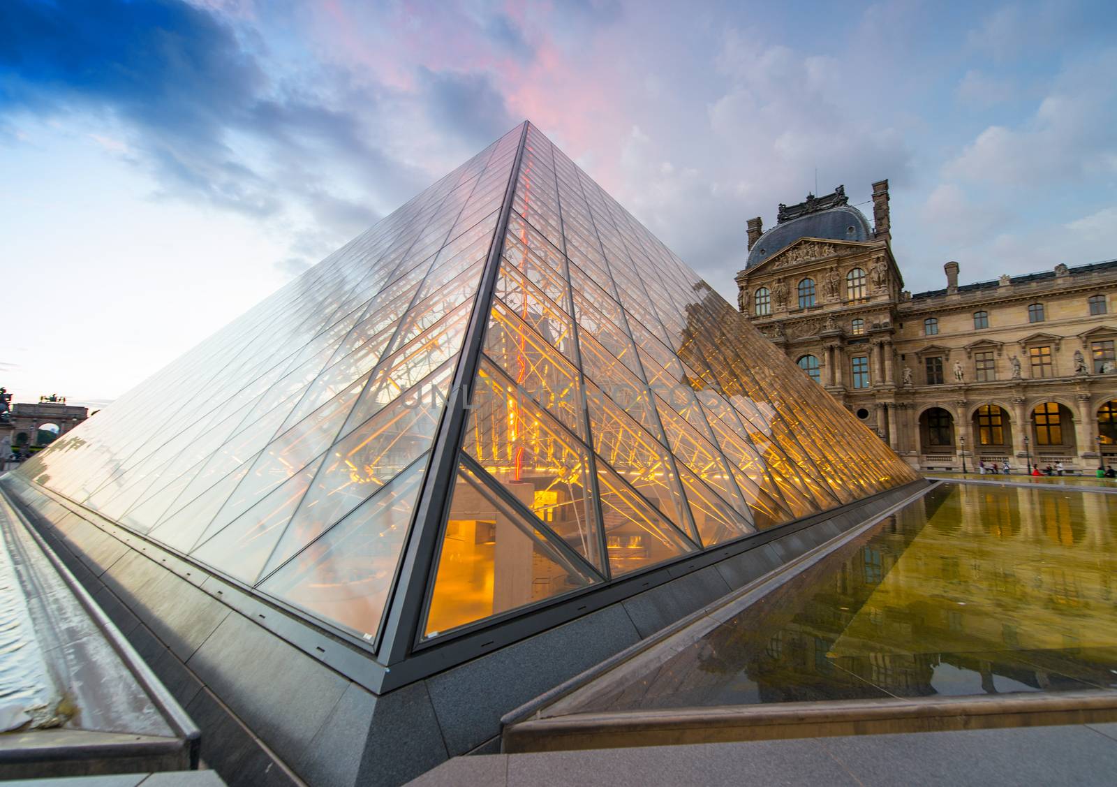 PARIS - JUNE 15 : Louvre museum at twilight in summer on June 15, 2014. Louvre museum is one of the world's largest museums with more than 8 million visitors each year