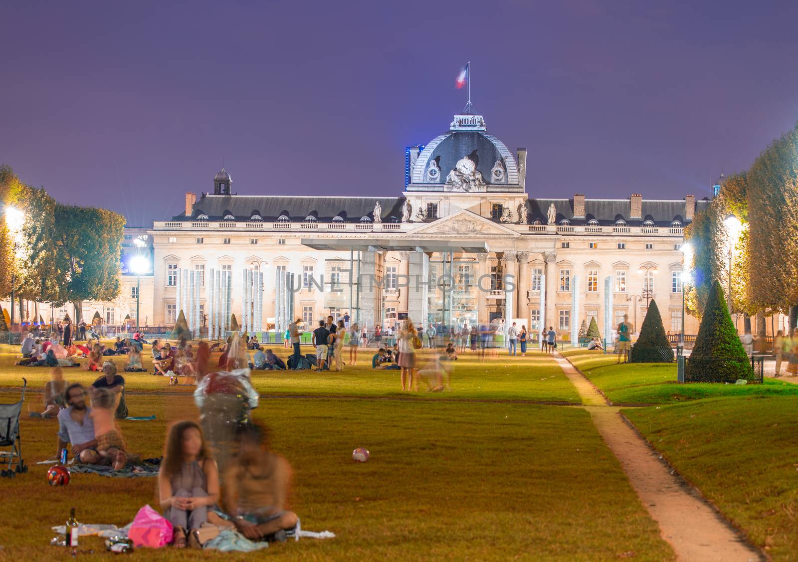 Tourists in Champs de Mars on a wonderful summer night.