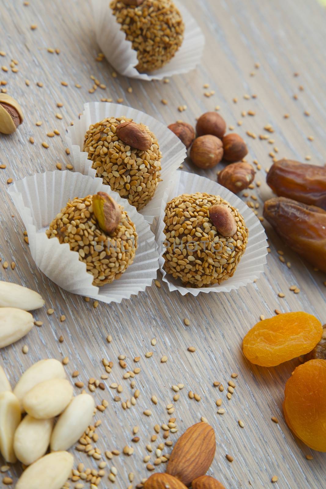 Homemade diet truffles with dried fruits and nut on an old black wooden surface