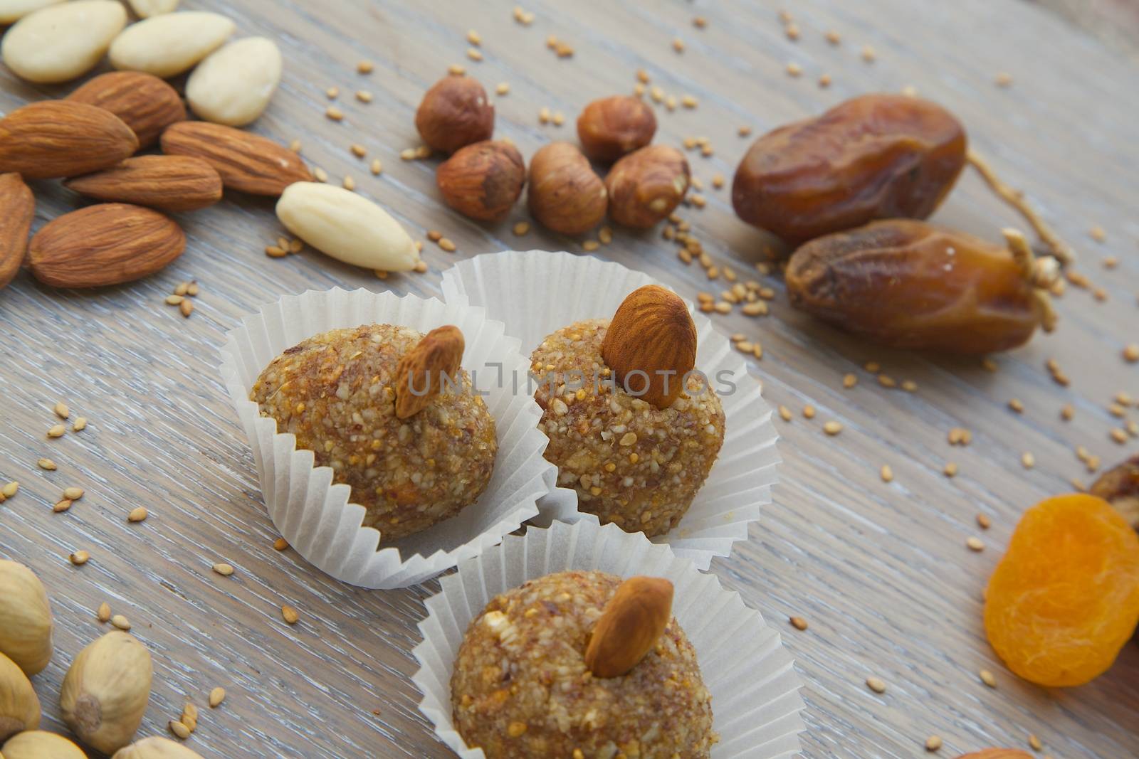 Fitness sweet -  homemade diet truffles with dried fruits paste and nuts on the glass plate