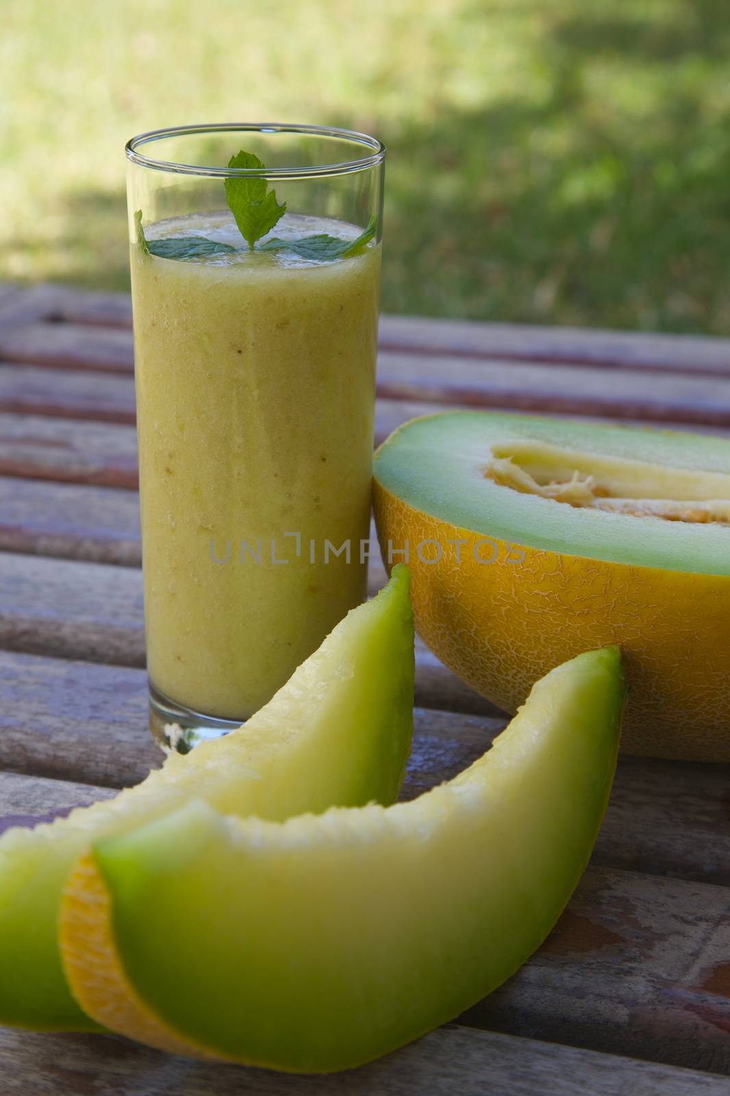 Melon smoothie with fresh peppermint leaves by tolikoff_photography