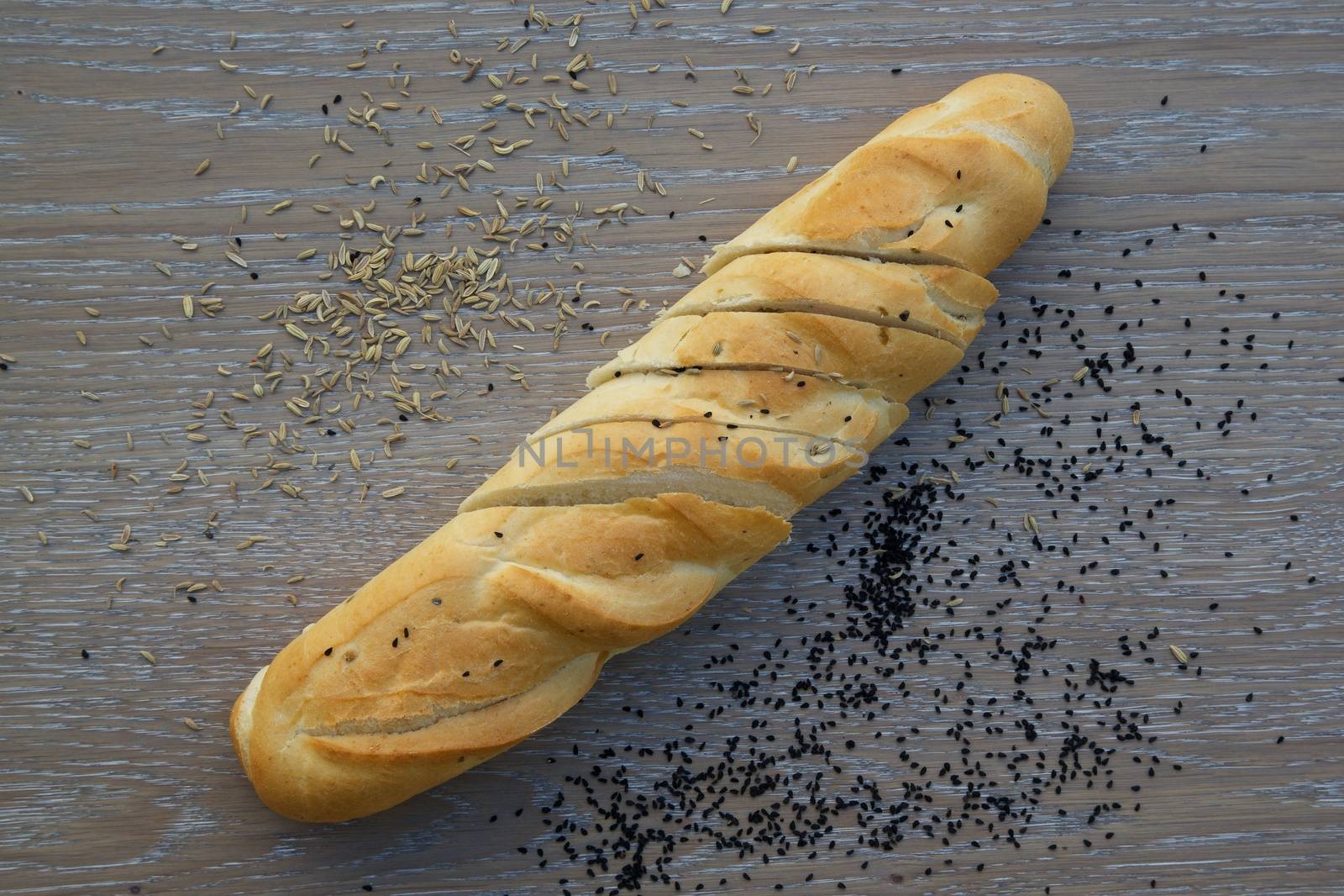 White French baguette with fennel seeds and black seed grains by tolikoff_photography