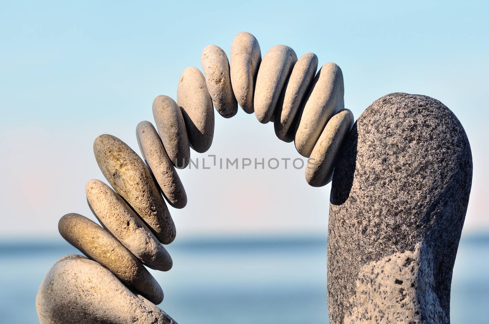 Arch of pebbles between of the stones on the coast
