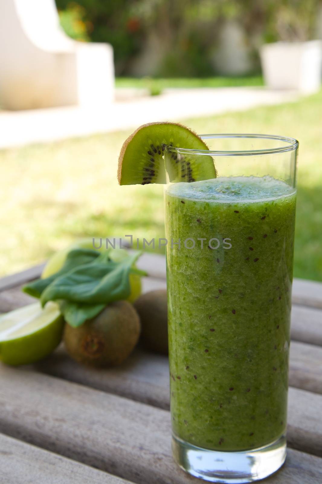 A glass of green smoothie by tolikoff_photography