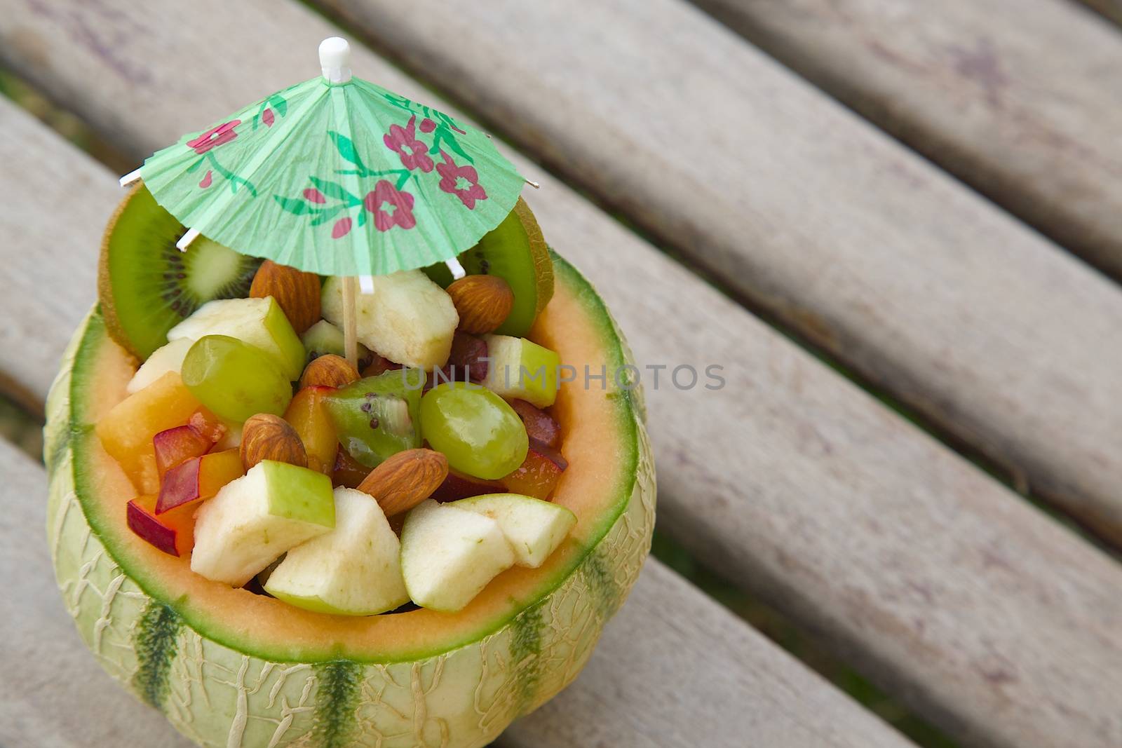 Vitamin dessert - fruit salad in the melon skin  by tolikoff_photography