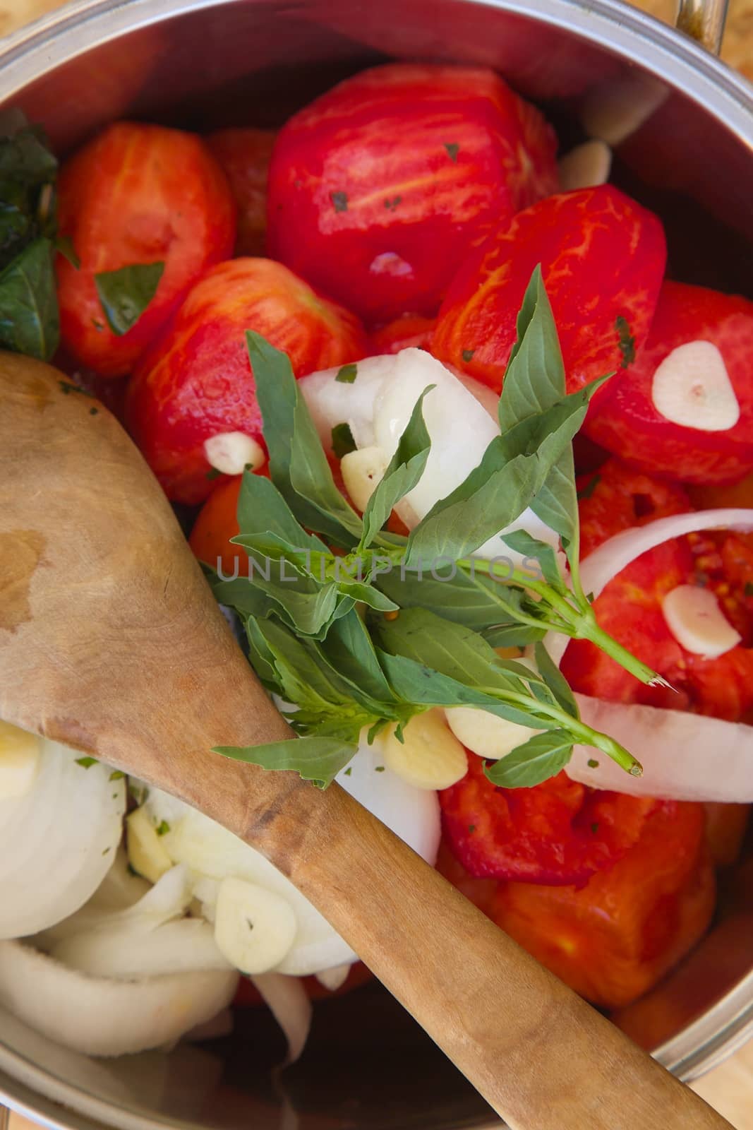 Prepared food ingredients for cooking Italian tomato sauce - salsa- in the pot by tolikoff_photography