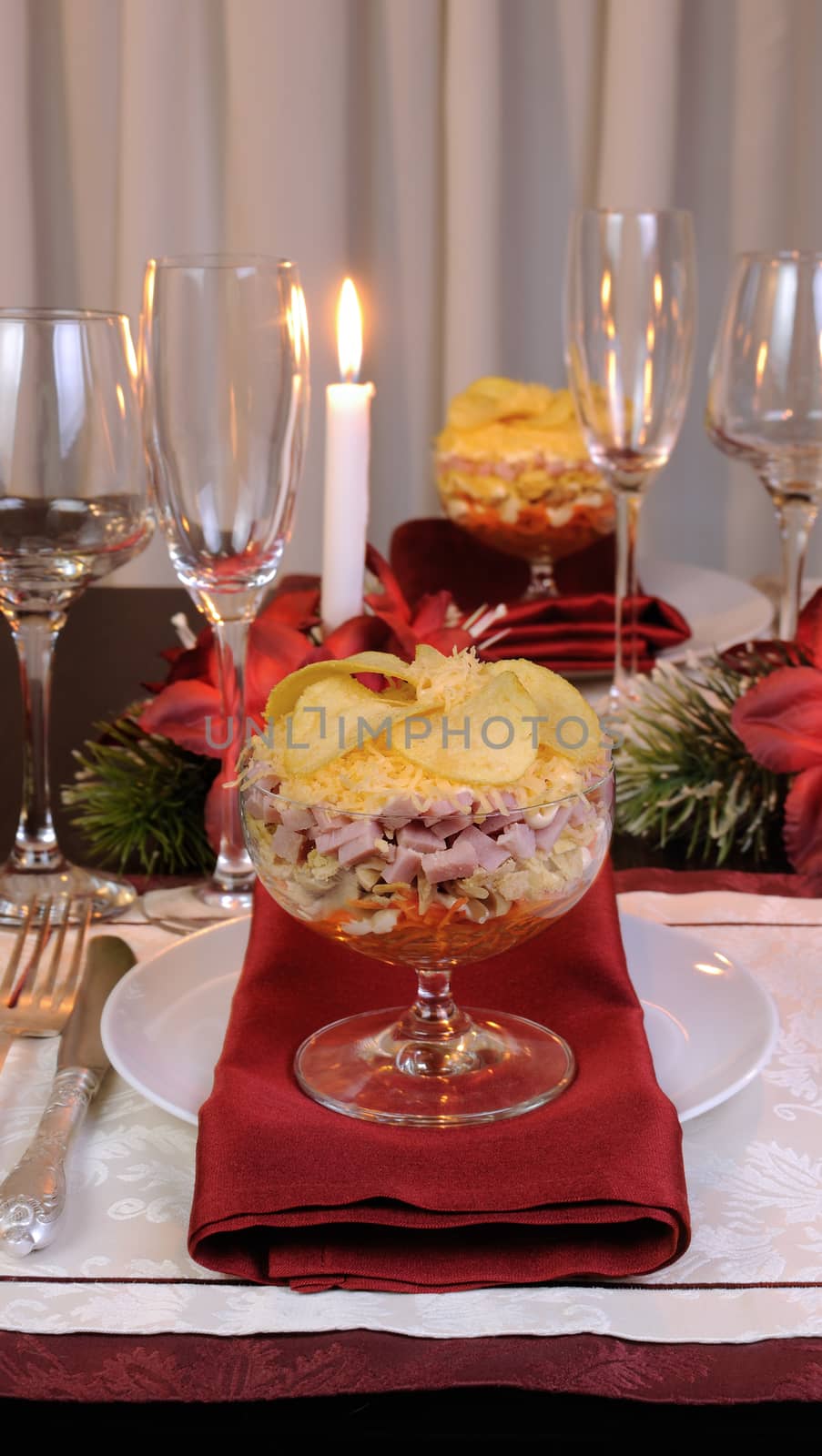 Festive layered salad in a glass goblet